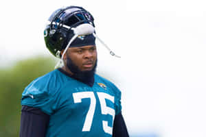 身穿青綠色球衣75號的足球員在訓練中戴著頭盔。 — NFL 美式足球 GIF 壁紙