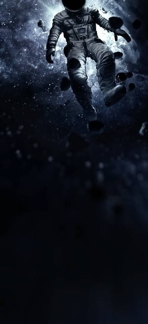 一名孤獨的太空人在深空中漂浮，周圍是漂浮的岩石和星星。 — Nothing Phone (2) 壁紙