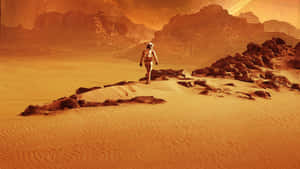 一名孤獨的太空人在火星上探索岩石遍佈的橙色沙漠。 — 火星 GIF 壁紙