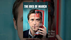 一名男子手持名為「The Ides of March」的雜誌，臉部部分被遮蓋。 — 三月 壁紙