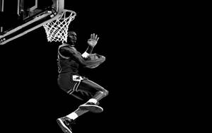 運動員在黑白攝影中進行強力灌籃。 — Jordan 標誌 GIF 壁紙