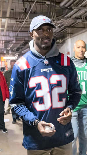 身穿愛國者隊球衣的男子在室內手持棒球 — NFL 美式足球 GIF 壁紙
