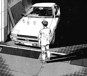 年輕男子在車庫門口夜間看著白色跑車。