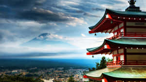 紅色寺廟帶有彎曲屋頂，在多雲天空下俯瞰城市和富士山。 — 靈性動態圖 壁紙