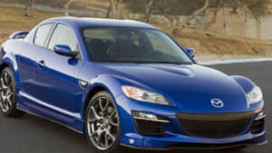 藍色Mazda RX-8跑車在日落時分的賽道上。 — Audi R8 GIF 壁紙