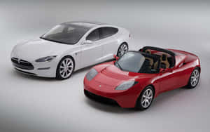 兩輛 Tesla 電動車 白色房車和紅色開篷車 在攝影棚內 — MacBook Pro M1 壁紙