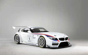 工作室中帶有紅藍條紋和贊助商標誌的白色BMW Z4賽車。 — Steam Deck 壁紙