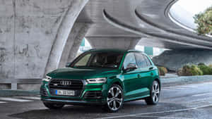 綠色Audi SQ5 SUV停泊在弧形混凝土天橋下。 — 奧迪 GIF 壁紙