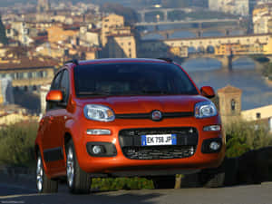 橙色Fiat Panda停泊，俯瞰佛羅倫斯、阿諾河和橋樑。 — 熊貓 壁紙