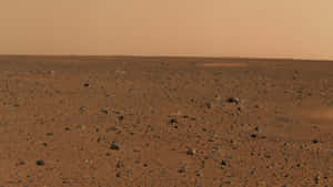 在塵土飛揚的橙色天空下的紅色岩石火星地形 — 火星 GIF 壁紙
