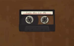 在棕色紋理背景上，一盒標有 Indie Mix Vol 5 的黑色卡式錄音帶 — 音樂美學 壁紙