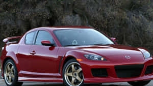 紅色萬事得RX-8跑車配金色輪圈，停泊在戶外樹木附近。 — Audi R8 GIF 壁紙
