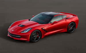 紅色雪佛蘭Corvette跑車，配黑色輪圈和紅色制動卡鉗，停在灰色路面上。 — Steam Deck OLED 壁紙