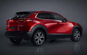 紅色Mazda CX-30 SUV在攝影棚內，反射地板和深色背景。 — Steam Deck OLED 壁紙