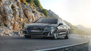 灰色奧迪 RS7 Sportback 在日落時分行駛在山路上 — 奧迪 GIF 壁紙