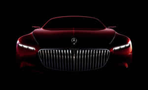 紅色 Mercedes-Maybach 概念車正面視圖，在黑色背景下車頭燈發光。 — MacBook Pro M1 壁紙
