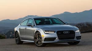 日落時銀色奧迪房車停泊在山路上。 — Audi R8 GIF 壁紙