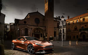 銅色Aston Martin停放在歷史悠久的意大利廣場，正值黃昏。 — Steam Deck OLED 壁紙