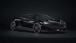 黑色McLaren跑車在工作室中，帶有戲劇性燈光。 — 麥拿侖 GIF 壁紙