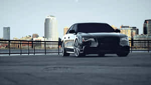 黑色奧迪房車停泊在城市天台，俯瞰城市天際線。 — Audi R8 GIF 壁紙