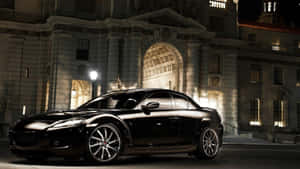 黑色跑車夜間停在一座燈光古典建築前。 — Audi R8 GIF 壁紙