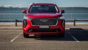 紅色Haval SUV停泊喺海邊停車場，享有海景。 — 酷車 壁紙