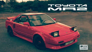 紅色豐田MR2跑車停在碎石上，日落時分。 — 酷車 壁紙