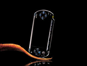 黑色Sony PSP遊戲機與橙色章魚觸手在反光表面上。 — 可愛動漫頭像gif 壁紙