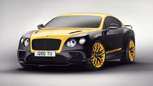 攝影棚內黃黑配色的賓利 Continental GT Speed，配備金色輪圈。 — iMac 壁紙
