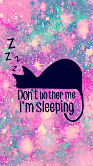 黑貓在宇宙背景上睡覺，帶有「Don't bother me I'm sleeping」文字。 — 淺粉紅色美學動圖 壁紙