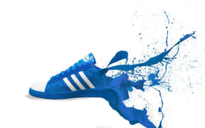 白色背景上帶有顏料飛濺效果的藍色 Adidas 運動鞋 — 2560x1600 壁紙