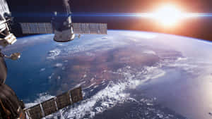 日出時地球軌道上的衛星，藍色海洋和白色雲層。 — 行星 壁紙