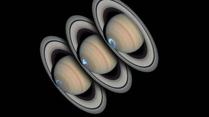 三個帶有光環的土星行星在黑色太空發出藍色光芒。 — 行星 壁紙