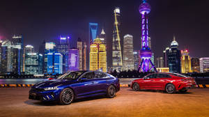 兩輛豪華轎車停在上海閃爍的天際線前。 — 唐人街 GIF 壁紙
