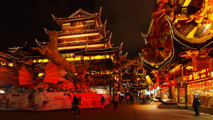 夜晚熱鬧的中國街道，有發光的建築物和行走的人們。 — 唐人街 GIF 壁紙