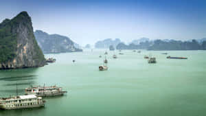 碧綠海灣，石灰岩喀斯特地貌和船隻，在清澈的藍天下
