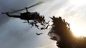 直升機和貨車擠滿了人，剪影襯著夕陽。