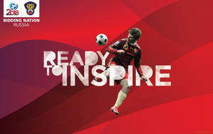 紅色球衣足球員在紅色背景上踢球，附有「Ready to Inspire」文字。