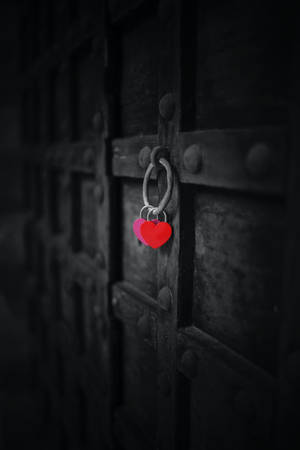 深色金屬門上帶有選擇性色彩的兩個紅色心形掛鎖。 — 中世紀 GIF 壁紙