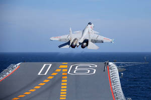 戰鬥機從航空母艦甲板起飛，海洋上空