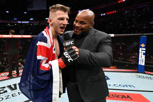 UFC拳手披著英國國旗在八角籠內與採訪者慶祝。