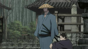 戴草帽武士站在跪著男人上方於竹林庭院