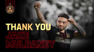 足球運動員舉起拳頭慶祝，文字感謝Jake Mulraney。 — 足球 壁紙
