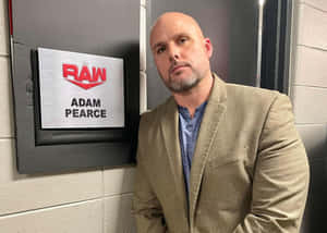 摔角手Adam Pearce站在他的RAW辦公室門牌前。 — 亞當·布羅迪 壁紙