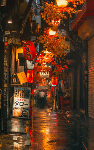 雨中的日本小巷，被發光的燈籠和秋葉照亮。 — Galaxy Tab S11 壁紙
