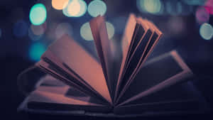 夜晚城市燈光下發光的打開的書，書頁呈扇形展開。
