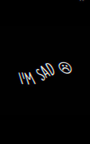 霓虹文字顯示 I'M SAD 並帶有悲傷表情符號在黑色背景上