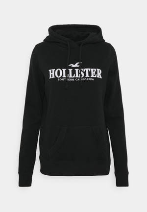 黑色Hollister連帽衛衣，帶白色標誌和抽繩。 — 簡潔 壁紙