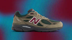 米色New Balance 990運動鞋，帶有栗色標誌，在彩色漸變背景上。