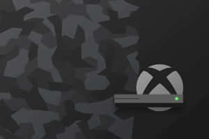 深色幾何背景上帶有綠色電源燈的Xbox主機